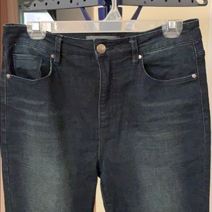 Jeans with distressed bottom.